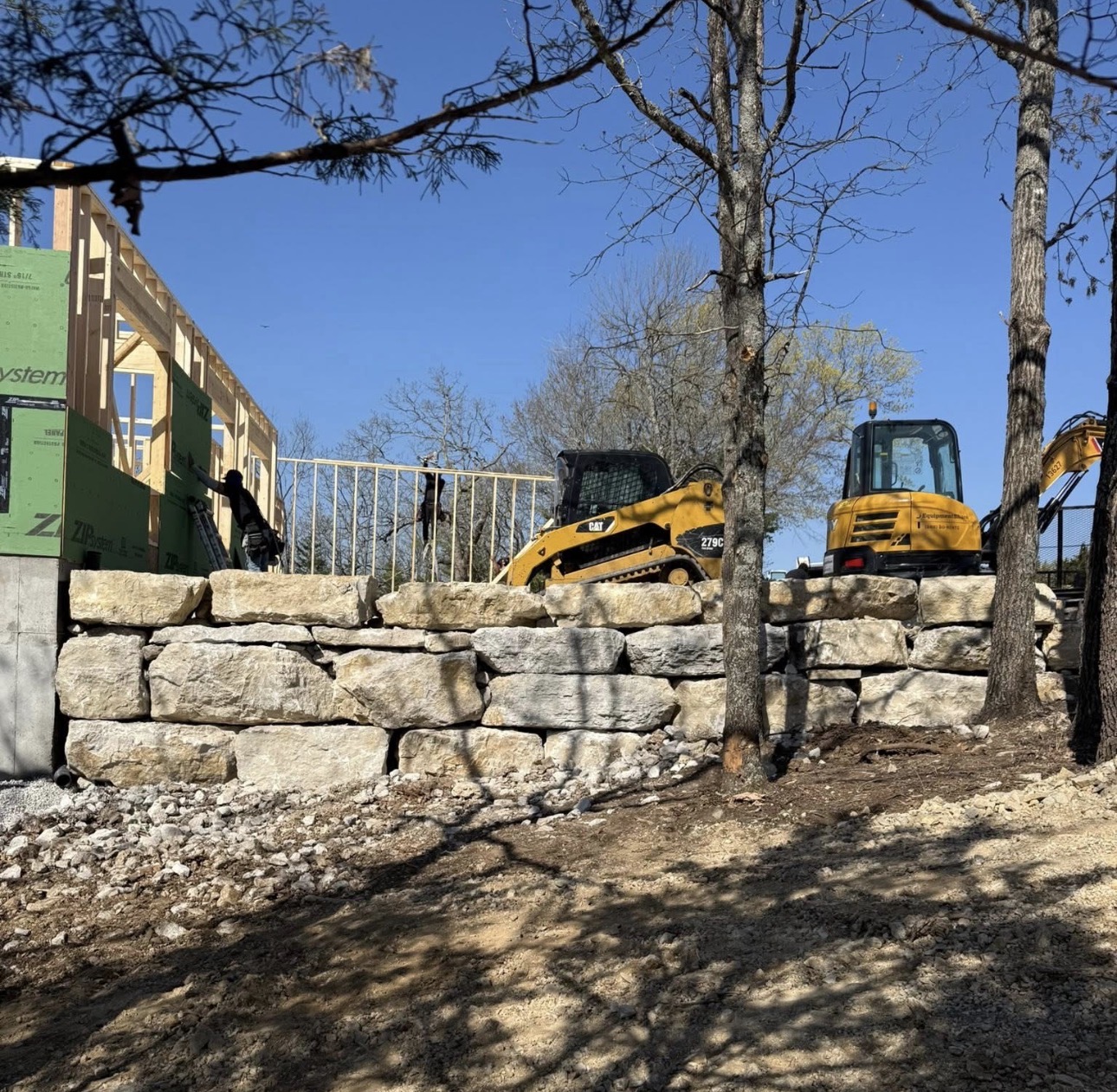 Skid steer at sunset on a Lakeside Hardscapes jobsite