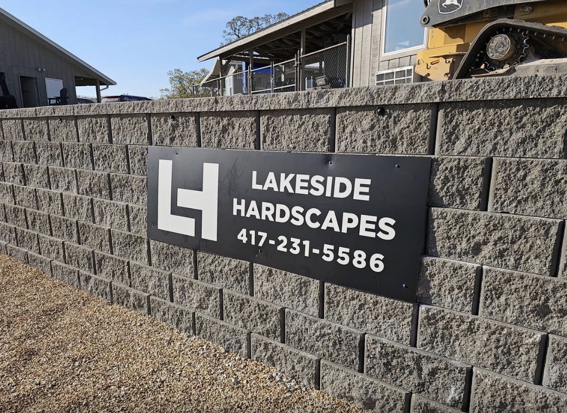 Lakeside Hardscapes shop sign on a finished retaining wall